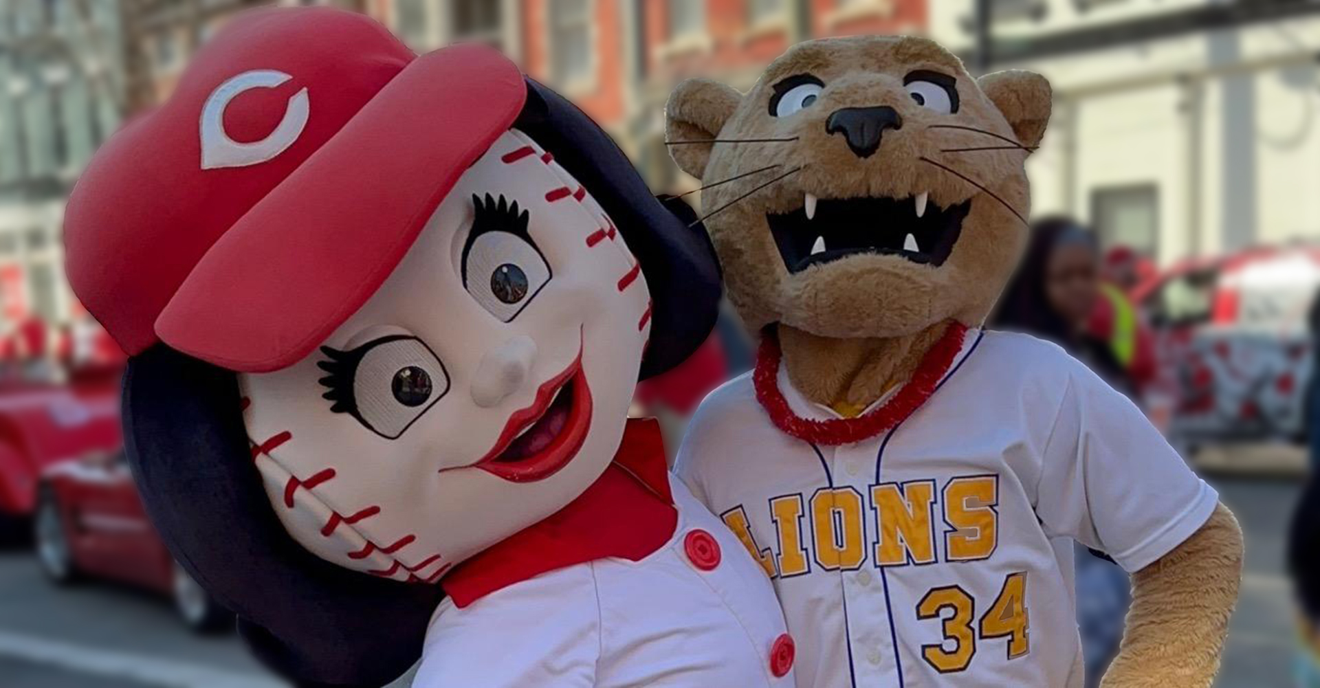 joe lion mascot with rosy red at parade downtown