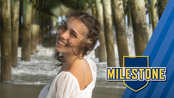 Mount St. Joseph University current student ciara tucker smiling by beach pier.