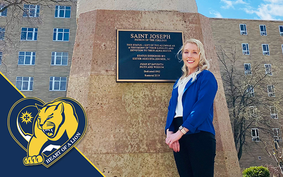 Rachael Bauer smiles in front of St. Joseph statue