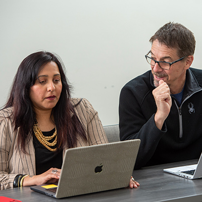 2 faculty members on laptop