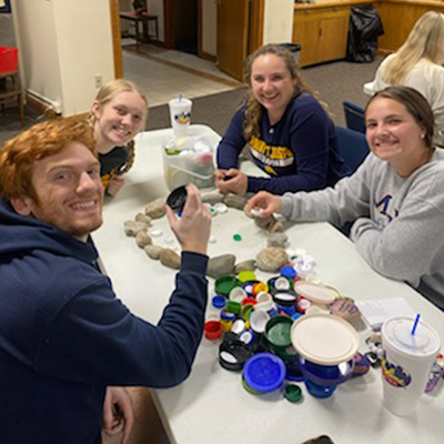Students gathered at a food pantry table