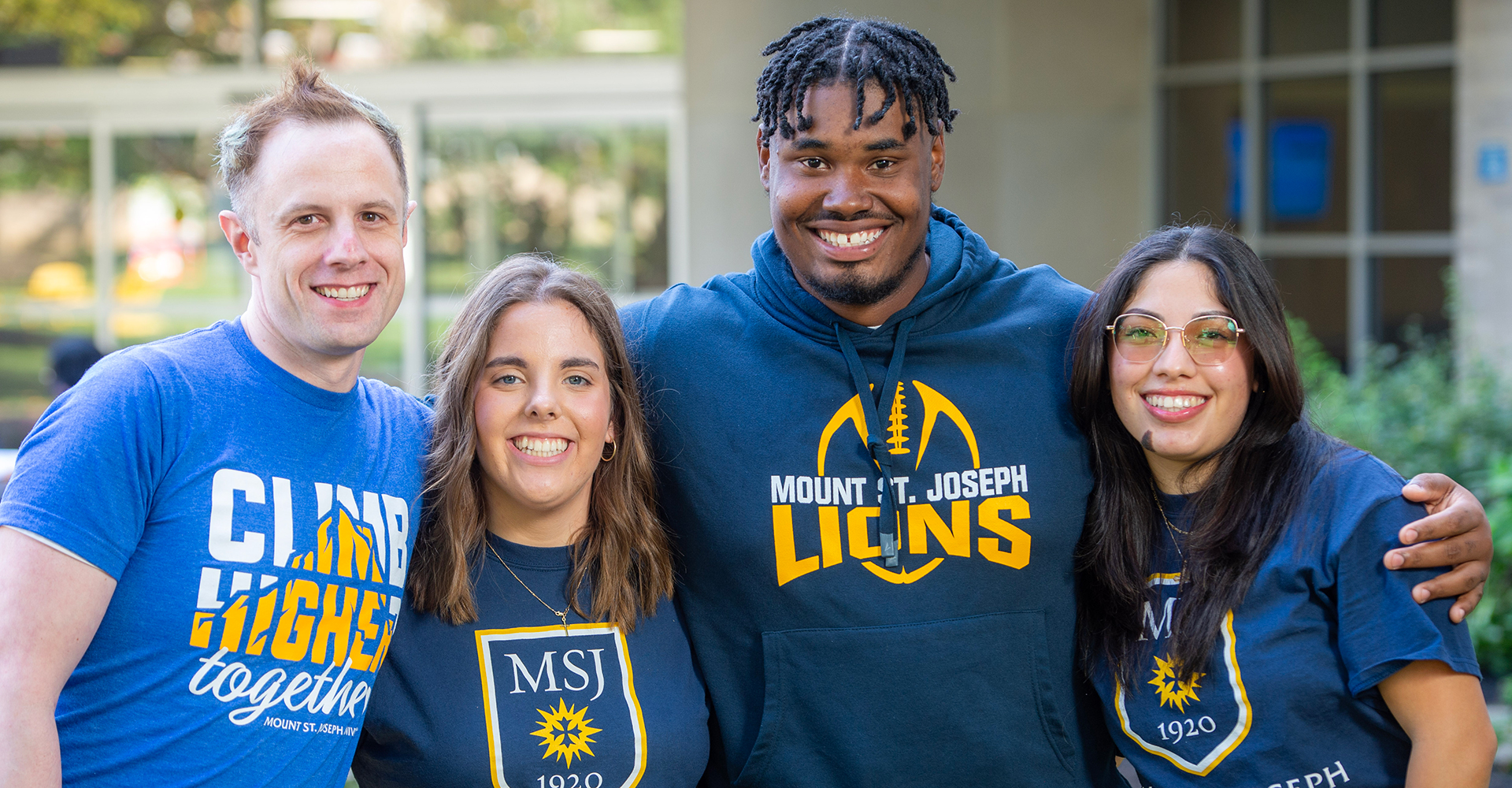 students at orientation smiling in group with joe lion mascot