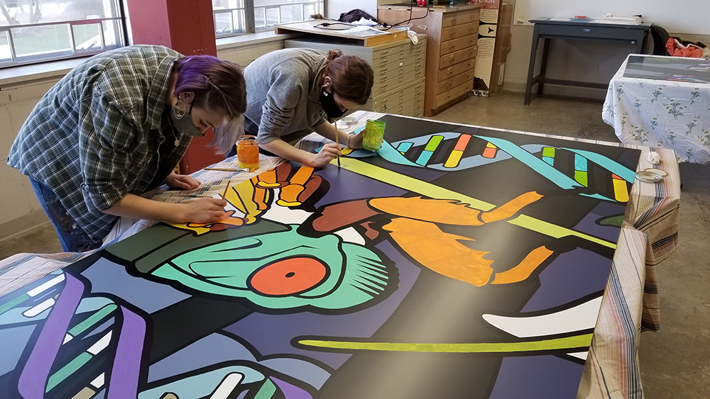 art guild students working on mural.