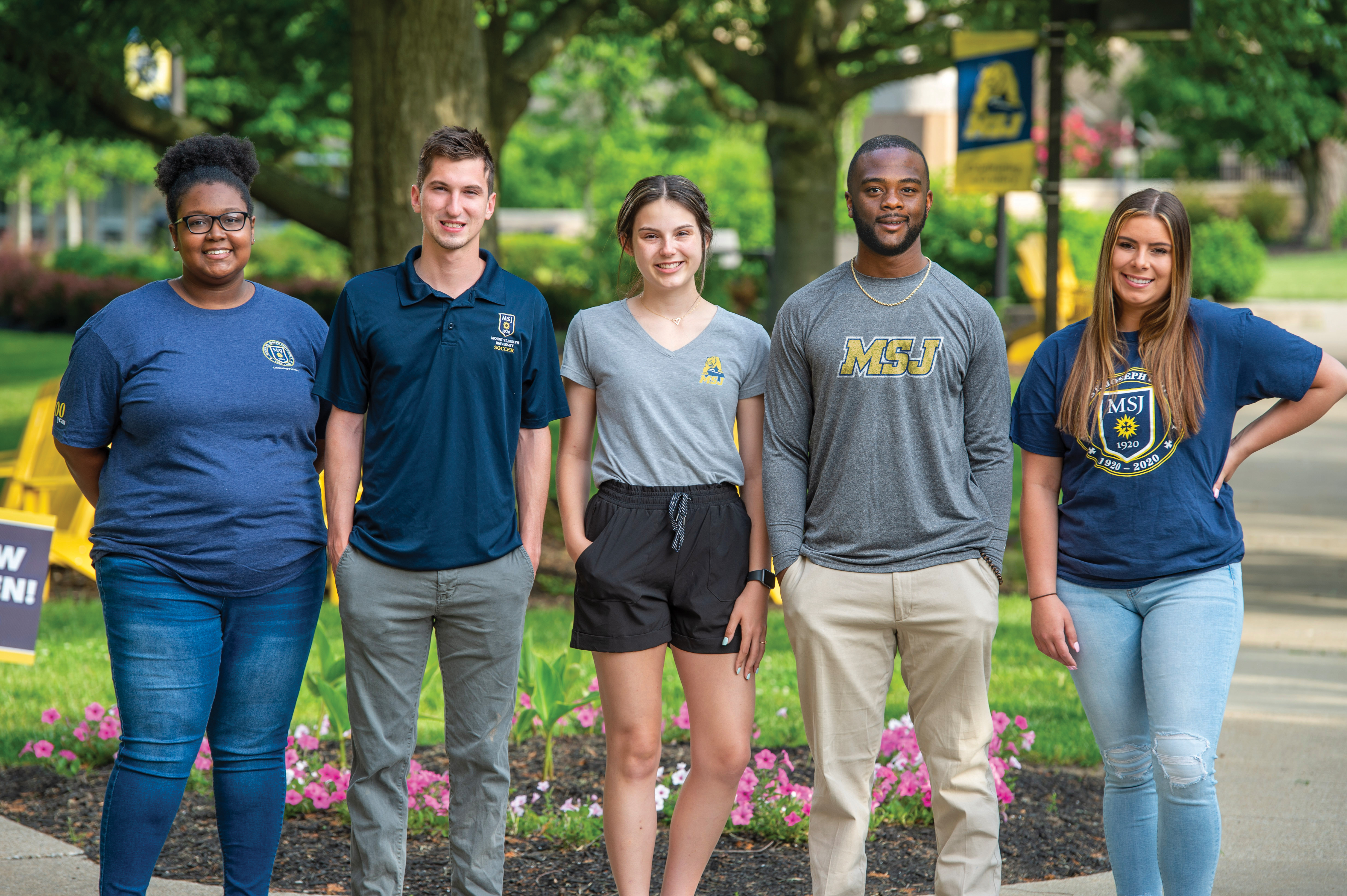 Diverse Mount St. Joseph University students smiling in quad