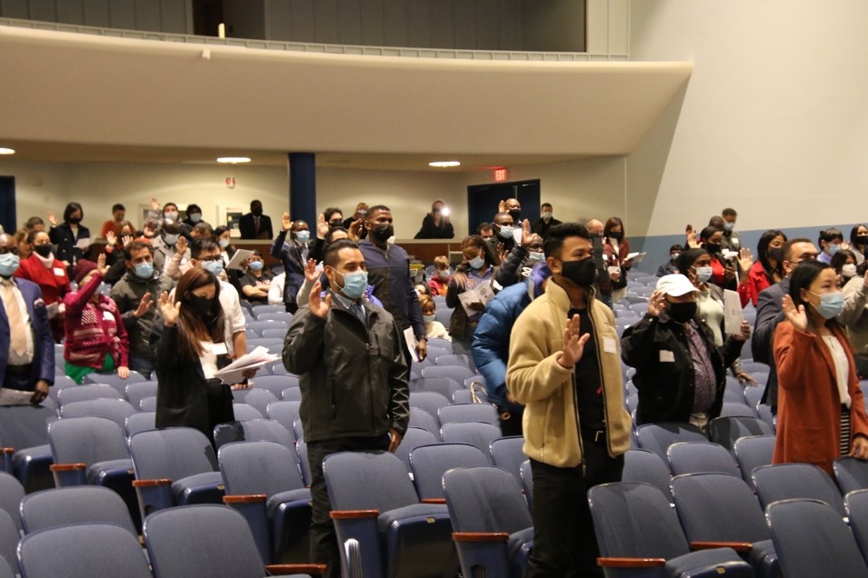 citizens taking oath in university theatre