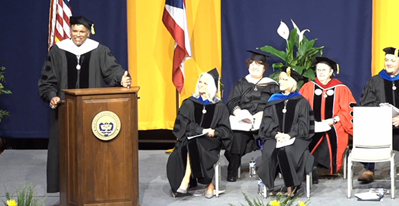 Former NFL player Anthony Munoz giving Commencement Speech at the podium at Mount St. Joseph University