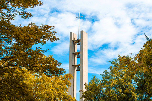 Sky view of Mater Dei Chapel bell tower above trees