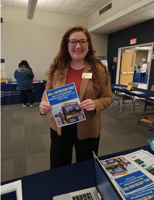 woman holding a flyer while smiling