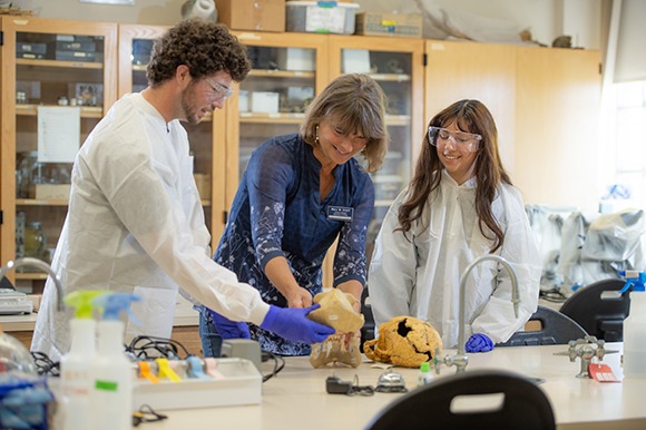 students and professor in lab