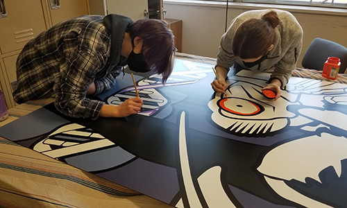 MSJ Art Guild students working in cicada mural in classroom.